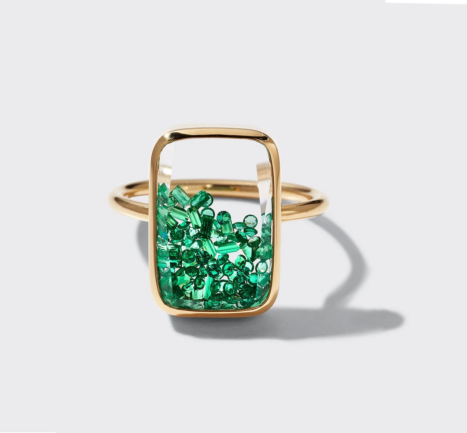 A 18 karat yellow gold ten fourteen petite emerald ring exuding elegance and sophistication